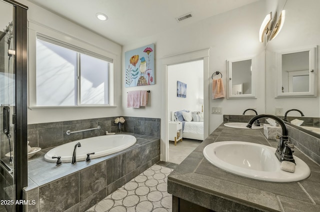 bathroom featuring a sink, double vanity, ensuite bathroom, visible vents, and a bath
