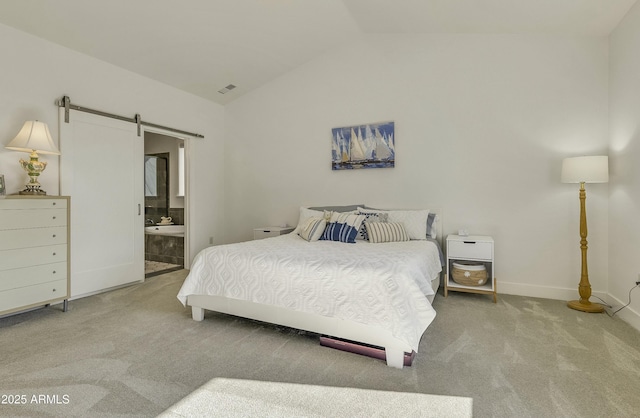 carpeted bedroom featuring a barn door, ensuite bath, baseboards, lofted ceiling, and visible vents