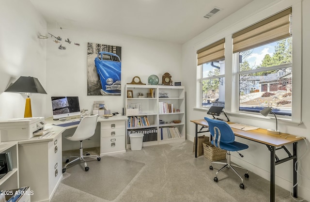 carpeted office with visible vents and baseboards