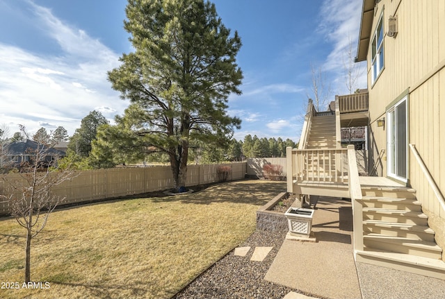 view of yard featuring stairway, a wooden deck, and a fenced backyard