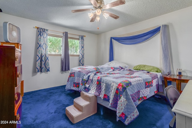 carpeted bedroom with ceiling fan and a textured ceiling