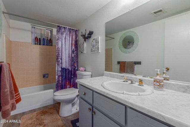 full bathroom featuring vanity, shower / bathtub combination with curtain, and toilet