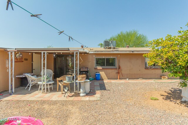 back of property with a patio area and central AC unit