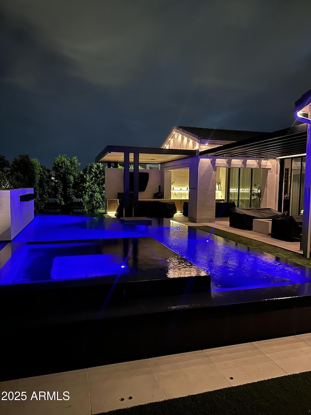 3684 E Boot Track Trl, Gilbert, AZ 85296 - pool at twilight featuring an in-ground hot tub, an outdoor pool, and a patio area