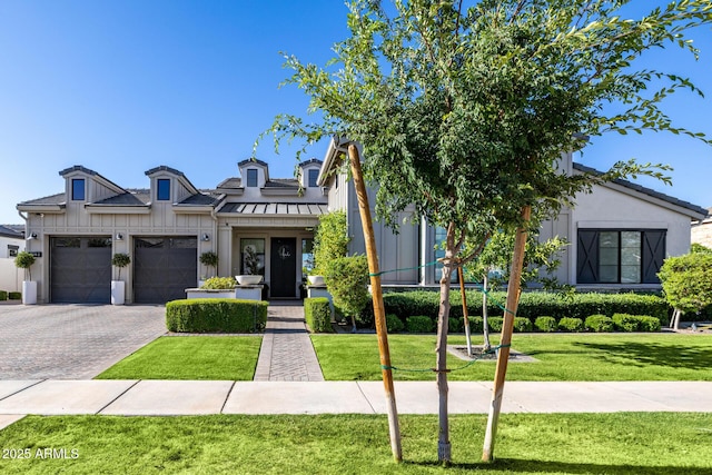 3684 E Boot Track Trl, Gilbert, AZ 85296 - modern farmhouse style home featuring a front yard, board and batten siding, decorative driveway, and an attached garage