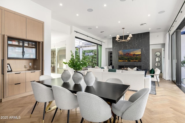 3684 E Boot Track Trl, Gilbert, AZ 85296 - dining room with a chandelier, recessed lighting, and a fireplace