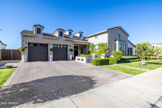 3684 E Boot Track Trl, Gilbert, AZ 85296 - view of front facade with board and batten siding, a garage, and decorative driveway