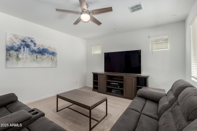 living room with ceiling fan, visible vents, light carpet, and a healthy amount of sunlight