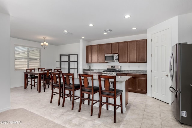 kitchen with visible vents, light tile patterned flooring, recessed lighting, a notable chandelier, and stainless steel appliances