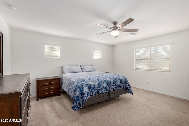 bedroom with baseboards, visible vents, multiple windows, and light carpet