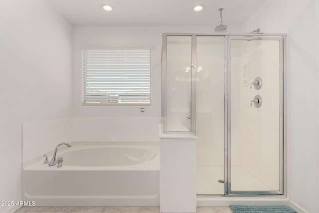 bathroom with recessed lighting, a garden tub, and a stall shower