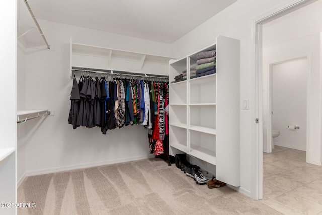 walk in closet featuring carpet flooring