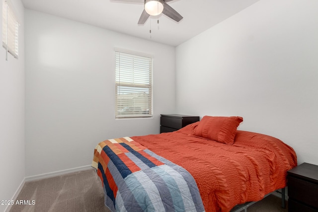 carpeted bedroom with a ceiling fan and baseboards