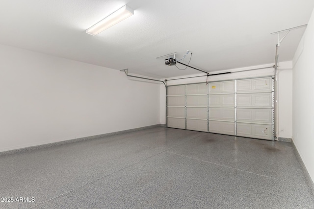 garage featuring baseboards and a garage door opener