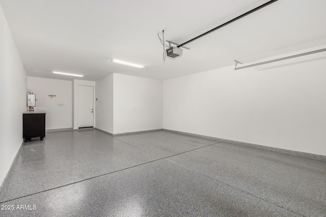 garage with baseboards and a garage door opener