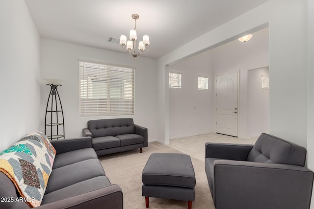 living room featuring light colored carpet, visible vents, and an inviting chandelier
