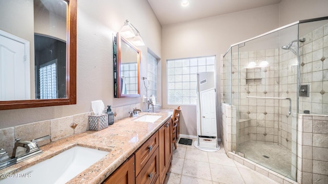 bathroom featuring tile patterned flooring, vanity, and an enclosed shower