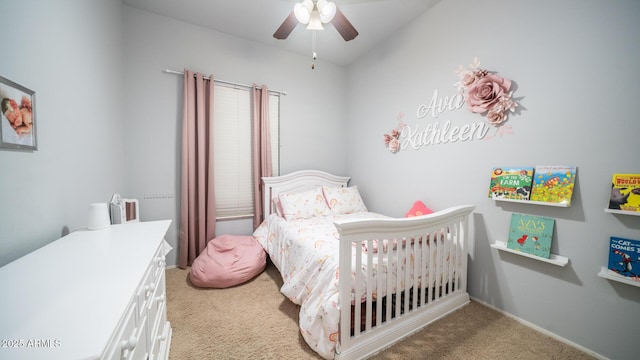 bedroom featuring light colored carpet and ceiling fan