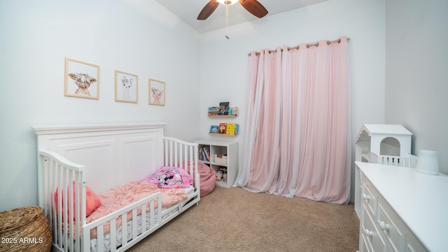 carpeted bedroom with a nursery area and ceiling fan