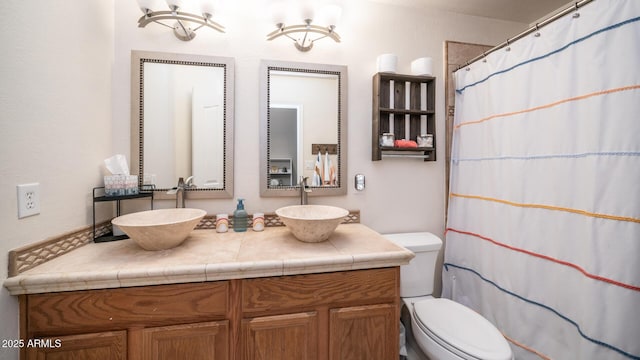 bathroom with vanity, walk in shower, and toilet