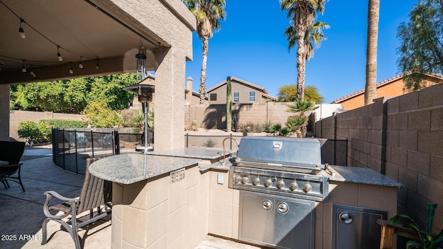 view of patio / terrace with area for grilling, grilling area, and a bar