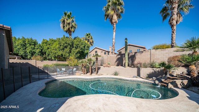 view of swimming pool with pool water feature