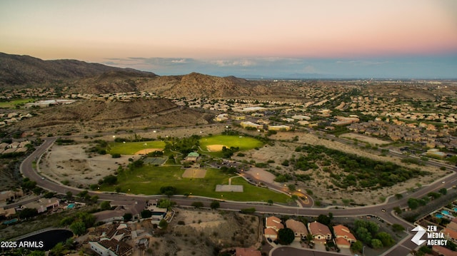 aerial view at dusk featuring a mountain view