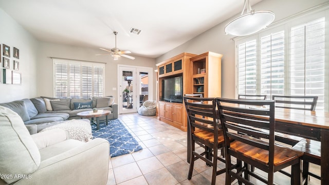 living room with light tile patterned floors and ceiling fan