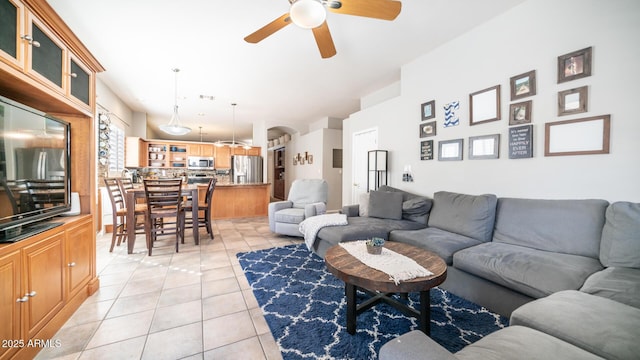 tiled living room with ceiling fan