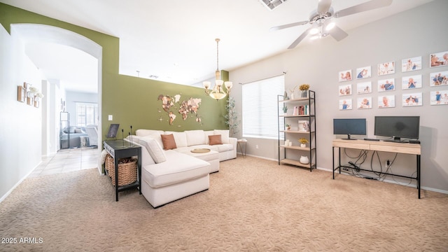 living room with ceiling fan with notable chandelier and light carpet