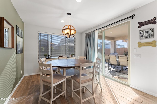 dining room with an inviting chandelier and hardwood / wood-style floors