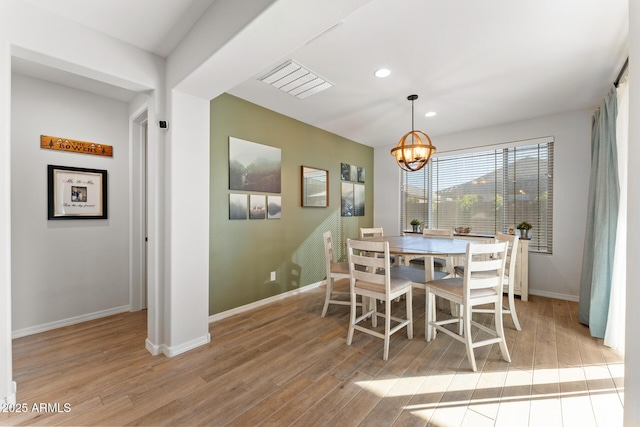 dining room featuring an inviting chandelier and light hardwood / wood-style floors