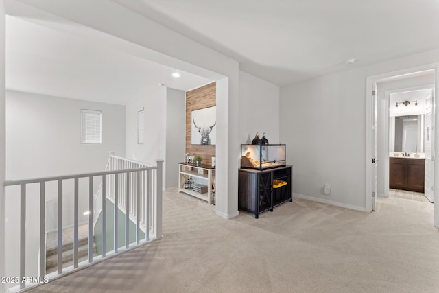 corridor featuring light colored carpet