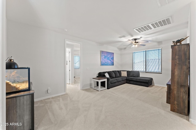 carpeted living room with ceiling fan