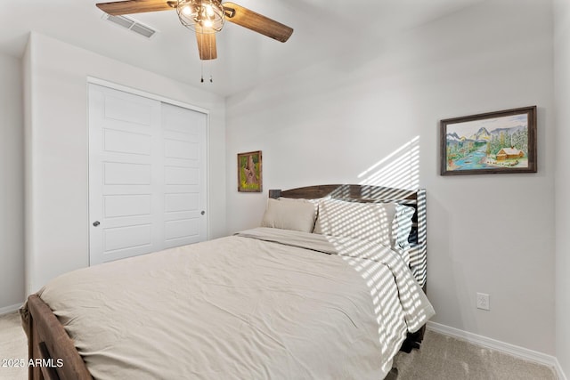 carpeted bedroom featuring ceiling fan and a closet