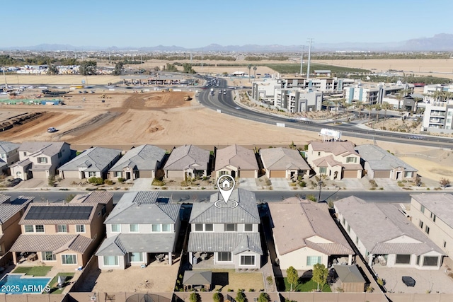 birds eye view of property with a mountain view