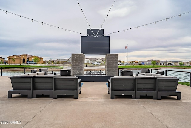 view of patio with an outdoor living space and a water view