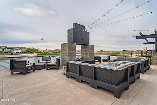 view of patio featuring an outdoor living space with a fire pit