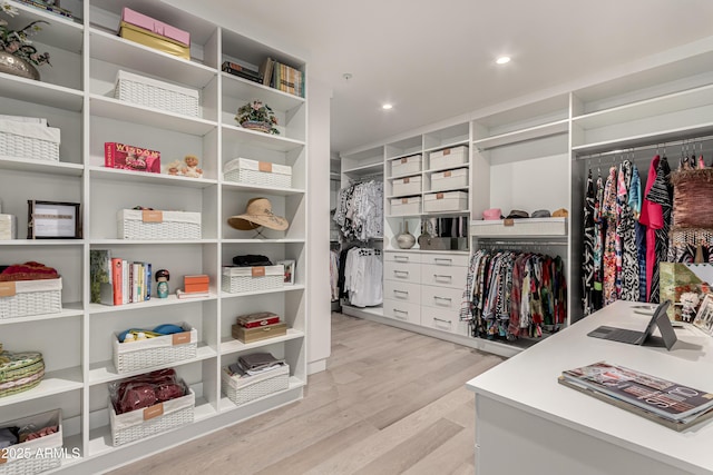 walk in closet with light wood-type flooring