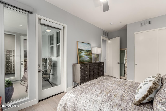 bedroom with visible vents, baseboards, wood finished floors, and a ceiling fan