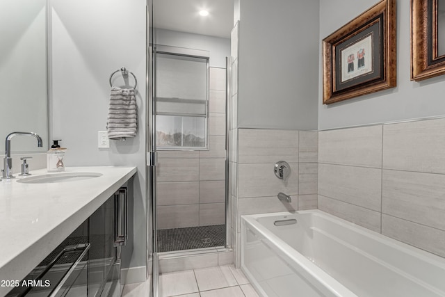 bathroom with tile patterned flooring, a shower stall, a bath, and vanity