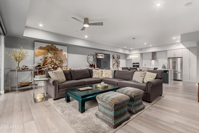 living room with recessed lighting and light wood-style flooring