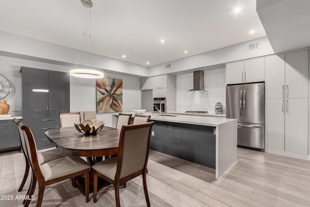 dining room with recessed lighting, visible vents, and light wood finished floors