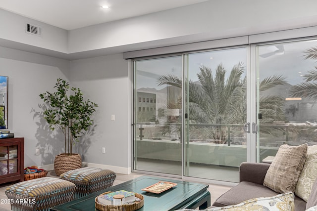 living room featuring baseboards and visible vents