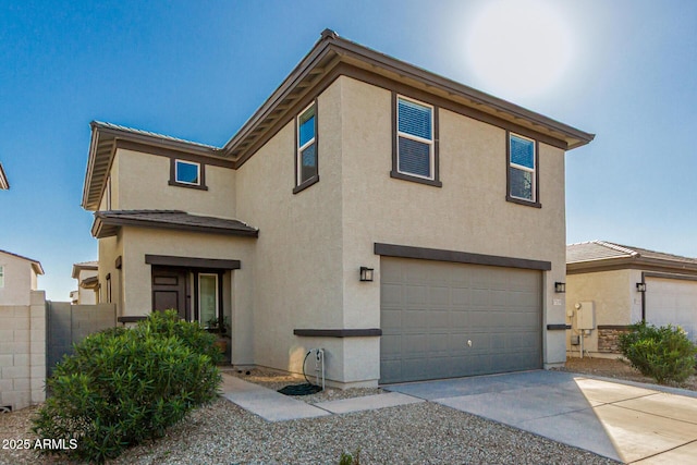 traditional-style home with concrete driveway, an attached garage, and stucco siding