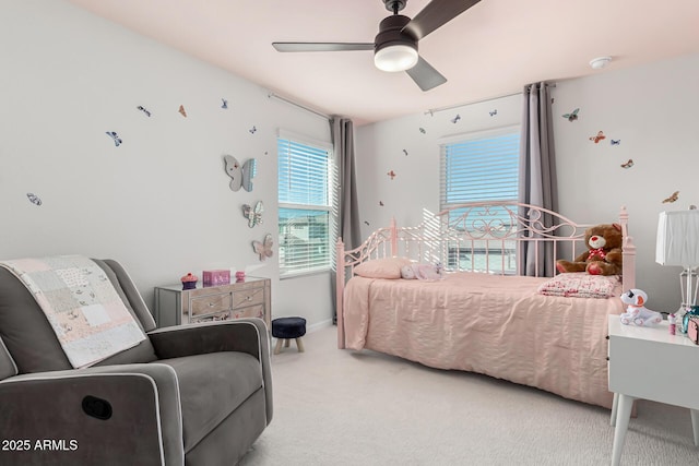 carpeted bedroom featuring baseboards and a ceiling fan