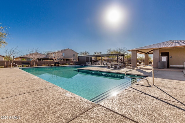 pool featuring a patio area and fence