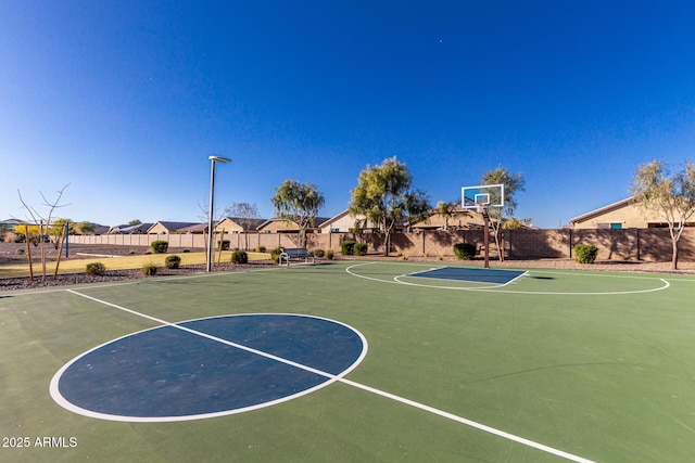 view of basketball court with community basketball court, fence, and a residential view