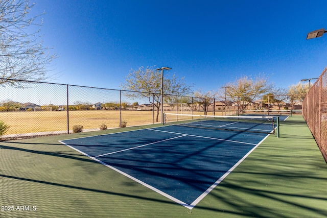 view of sport court featuring fence