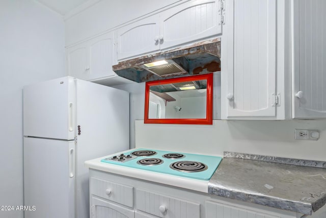 kitchen featuring white cabinets and white appliances